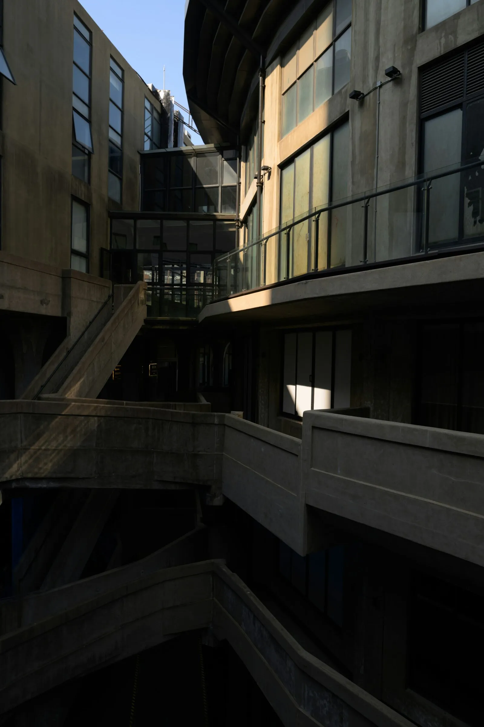 Concrete galleries and stairs around a deep courtyard